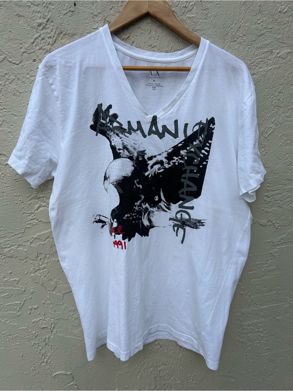 Armani Exchange white V-neck T-shirt featuring a large black graphic of an eagle